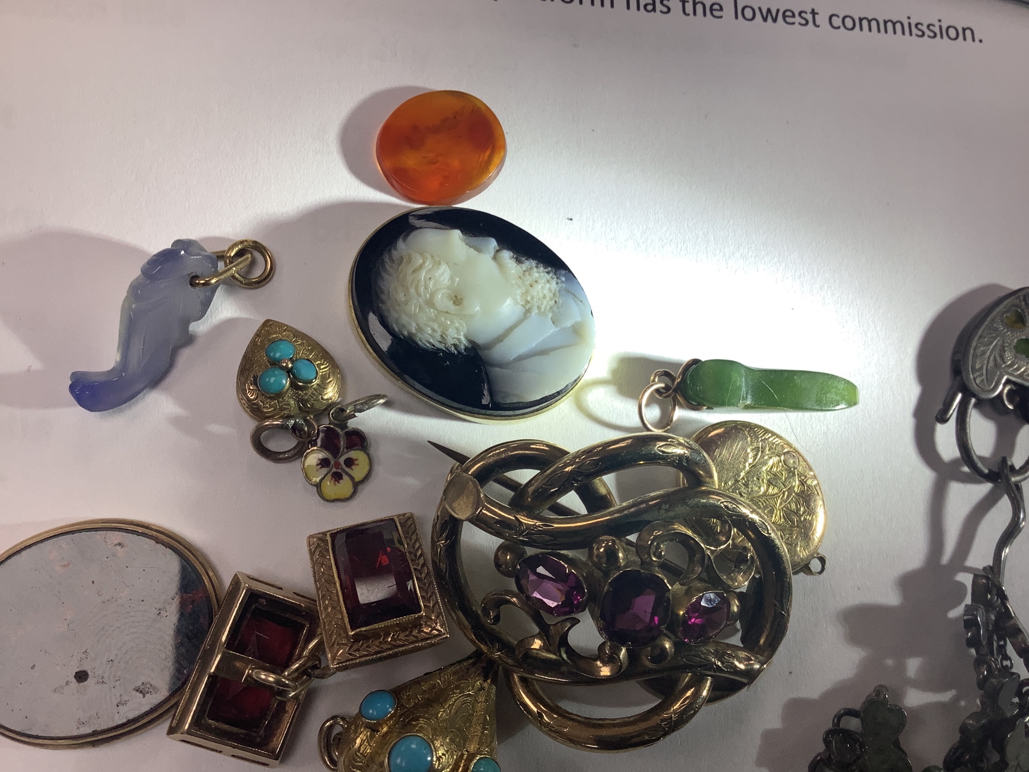 A small group of Victorian and later jewellery including a 1920's silver 'shamrock' bracelet, garnet set scroll brooch, bloodstone set mourning pendant(lacking back), small charms including enamel, sardonyx cameo etc.